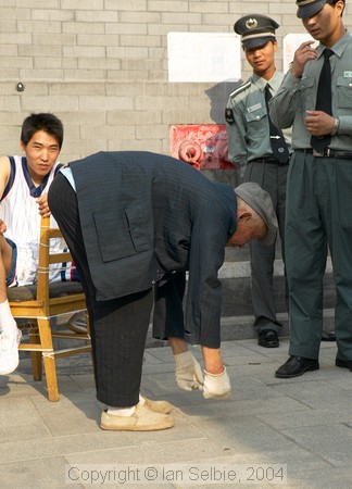 Old man demonstrating that he still flexible, Gardens of the Forbidden City, Beijing