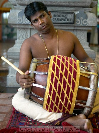 Drum player at celebration of the birthday of Lord Ganesha at Sri Senpaga Vinayagar Temple, Ceylon Road, Singapore