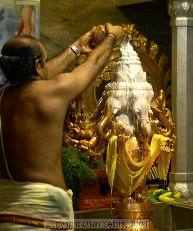 Pouring milk over the statue of Lord Ganesha on his birthday at Sri Senpaga Vinayagar Temple, Ceylon Road, Singapore
