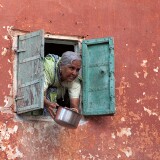 Old lady thowing out the dishwater (?), Jaipur