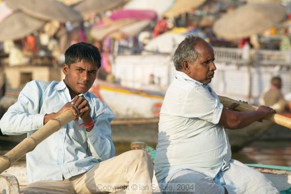 Boatmen rowing along the Ganges near Dashaswadedh Ghat, Varanasi
