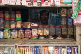 Shopkeeper peers from the darkness of his shop,  old Varanasi
