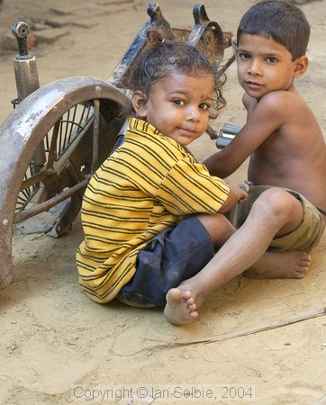 In the countryside near Varanasi: children playing with the remains of a motorcycle