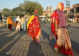 Brightly dressed women cross the street in the early morning, Jaipur
