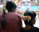 Spectators with flowers in their hair at the Thimithi (fire walking) ceremony, Singapore 2003