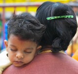 Mother and tired little boy at the Thimithi (fire walking) ceremony, Singapore 2003
