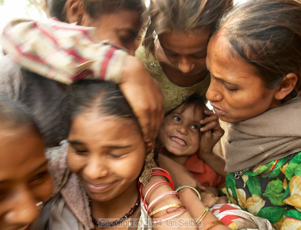 Women young and old crowding to get into the photo, Delhi