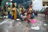 Women and children at the village water pump in the street market near the Tomb of Nizammudin, Delhi