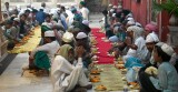 Men lined up with their food waiting for the break-fast at the Tomb of Nizammudin, Delhi