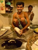 Man preparing bread for baking near  the Tomb of Nizammudin, Delhi