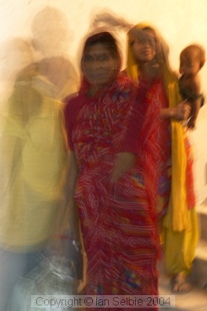 Behind the scenes at the Delhi arts and crafts exhibition, workers are carrying building materials up the shadowy stairway.  The baby came along for the ride.