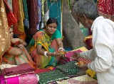 Two sales ladies buying lunch at the Janpath Lane textiles market, Delhi
