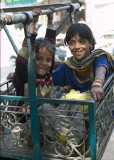 Children having the time of their life in a small hand-operated "ferris wheel" in Chandni Chowk, Old Delhi