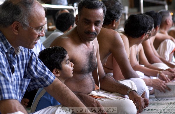 Father explaining to his son at celebration of the Full Moon at Sri Senpaga Vinayagar Temple, Ceylon Road, Singapore