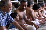 Father explaining to his son at celebration of the Full Moon at Sri Senpaga Vinayagar Temple, Ceylon Road, Singapore