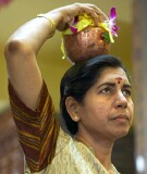 Woman carrying pot of milk on her head at celebration of the birthday of Lord Ganesha at Sri Senpaga Vinayagar Temple, Ceylon Road, Singapore