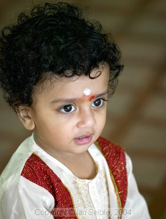 Child watching celebration of the Depavali Festival at Sri Senpaga Vinayagar Temple, Ceylon Road, Singapore