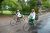 Cyclists coming through the south gate of Angkor Thom and across the Rainbow Bridge