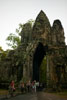Cyclists pass through the Gopuram at the South Gate of Angkor Thom