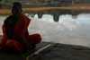 Monk by the moat at Angkor Wat