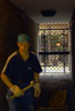 Workman in the shadows of a gateway