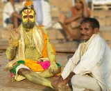 The Ganges river, Varanasi - a "sadhu" - most likely a business proposition rather than a holy mission, gets a foot massage.   Even sadhus get sore feet?