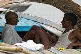 Boatmen resting by the side of the Ganges as the sun gets higher