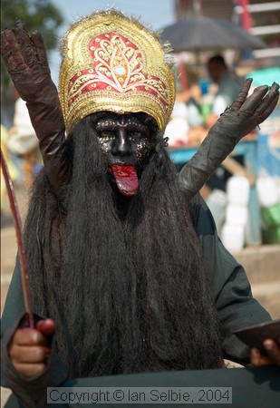 Dressed up as Kali to collect a rupee or two, by the Ganges, Varanasi