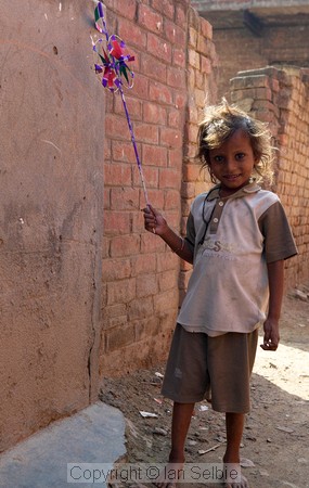 Child playing in an alley near the silk factory, Varanasi