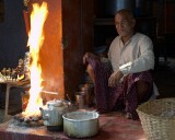 Everyday life in the narrow streets of old Varanasi: the old man has let his milk boil over but seems more amused than upset
