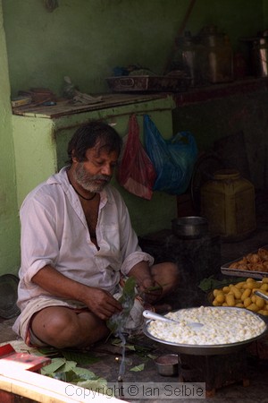Shopkeeper boiling curds, old Varanasi
