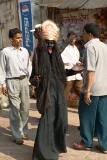 Dressed as Kali and on the way to the Ghats to collect donations, Varanasi