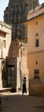 Small boys running through narrow street with Hindu temple in the background, Jaipur