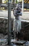 Man having a cold shower on the railway tracks, Jaipur