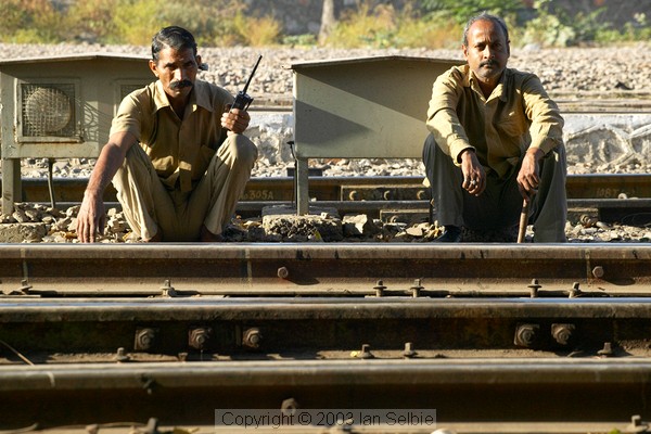 Railway work men sitting by the tracks, Jaipur Station