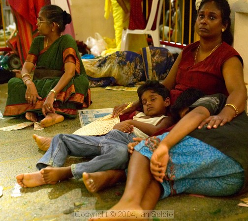 Tired spectators at the Thimithi (fire walking) ceremony, Singapore 2003