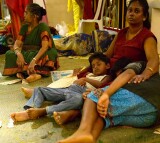 Tired spectators at the Thimithi (fire walking) ceremony, Singapore 2003