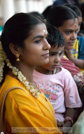 Mother and child watching the Thimithi (fire walking) ceremony, Singapore 2003