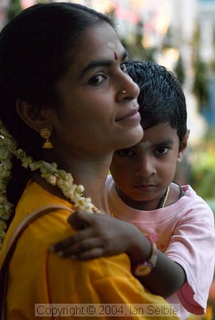 Mother and child watching the Thimithi (fire walking) ceremony, Singapore 2003