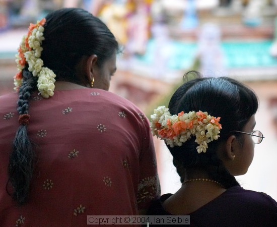 Spectators with flowers in their hair at the Thimithi (fire walking) ceremony, Singapore 2003