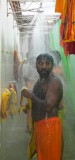 Celebrant showering after the Thimithi (fire walking) ceremony, Singapore 2003